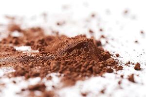 Cocoa powder dust against a soft transparent white surface, adding richness to designs photo