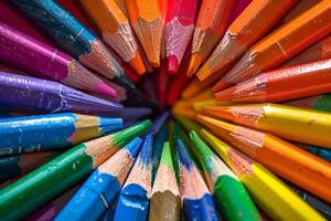Rainbow-colored crayons arranged transparently in a circular pattern photo