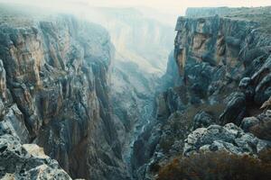 A breathtaking canyon vista, with sheer cliffs plunging into a deep gorge below photo