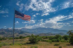 American flag on a pole against a mountain landscape photo