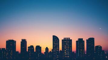 Modern buildings outlined against twilight sky photo