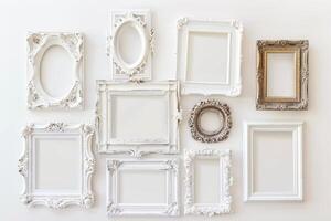A collection of white frames with a gold frame in the middle. The frames are arranged in a row and are all different sizes photo