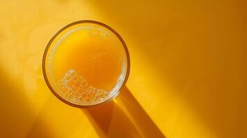 Top-down view of a spinning glass of orange juice with copy space photo