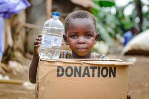 A young black boy is holding a box that says donation on it. photo