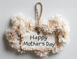 A bouquet of white flowers with a tag that says Happy Mother's Day photo