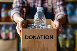 A person is holding a donation box .donation and volunteering concept . photo