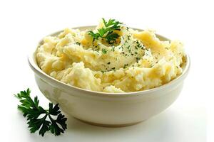 a dish of mashed potatoes with parsley in a bowl . photo