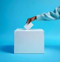 Woman hand putting paper into ballot box, close up view, photo
