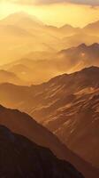 Mountain ridges bathed in the golden light of dawn photo