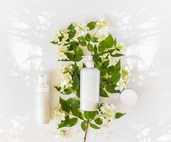 bottles for branding and label on a blooming apple branch with sun glare photo