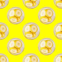 Seamless pattern of banana slices on a trendy yellow background photo