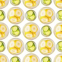 Seamless pattern of banana and cucumber slices on a white background photo