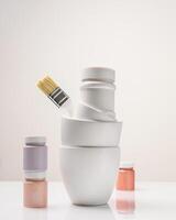Paint cans, jars and a brush on a light background with copy space photo