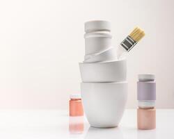 Paint cans, jars and a brush on a light background with copy space photo