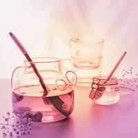Glass teapot, jar with honey and two glass cups photo