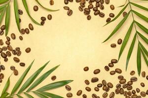 Coffee beans and palm leaves on a craft paper with copy space photo