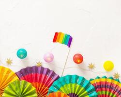 Lgbt flag with colorful paper fans and lightening on a white background with place for text photo