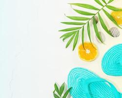 Summer holidays composition with flip-flop, palm leaves and citrus fruits photo