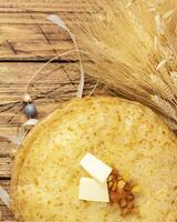 Home made fried crepes, jar with honey, sheaf of wheat photo