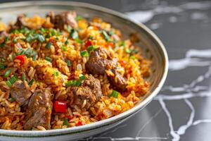 A plate of Kebuli with mutton on a marble countertop photo