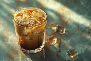 A cup of iced coffee on a marble countertop photo