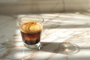 A cup of espresso on a marble countertop photo