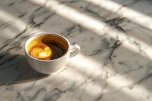 A cup of americano coffee on a marble countertop photo
