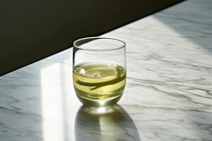 A cup of Green Tea on a marble countertop photo