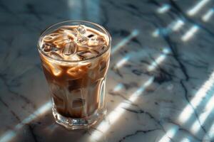 A cup of iced coffee on a marble countertop photo