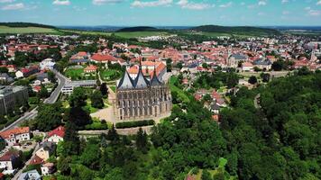 Aerial orbiting view of St. Barbara cathedral and chateau in Kutna Hora Czechia spring 2024 video