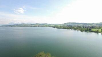 Cinematic aerial view of tree island in the middle of a lake landscape scenery video