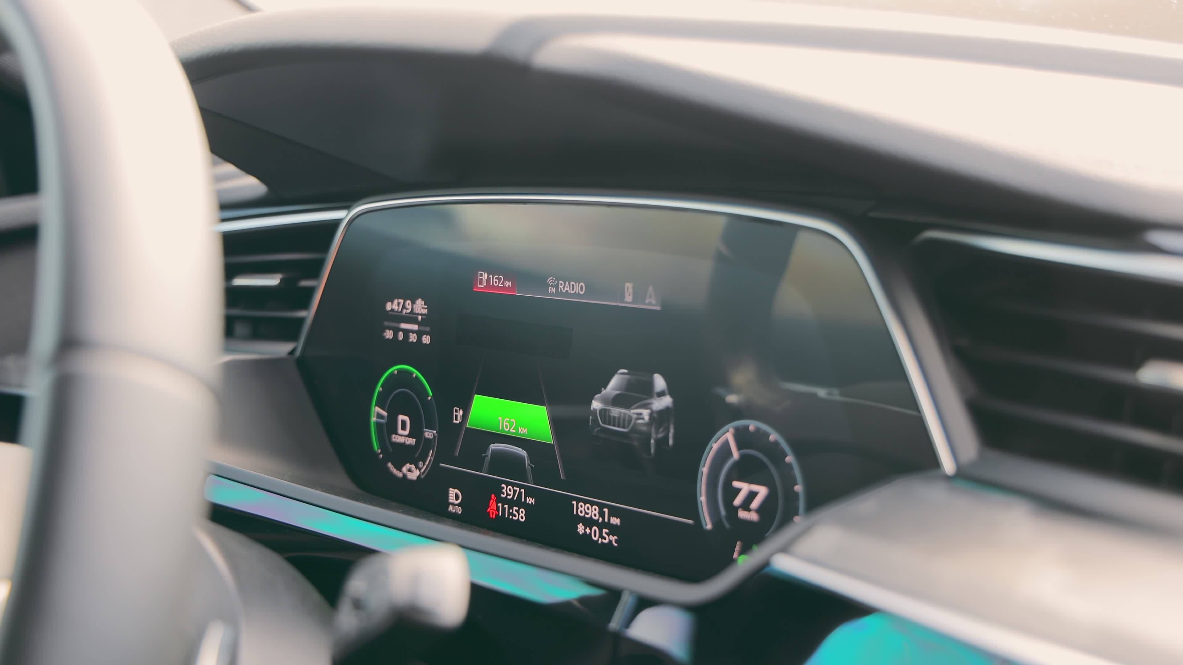 Dashboard of an electric car while driving. Speedometer and tachometer