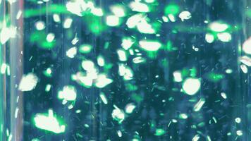 Blurred air bubbles moving up in a green flask. Blurred background. video