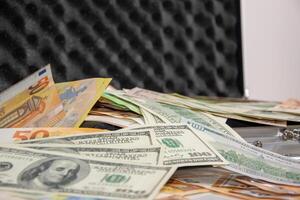 Close-up of a stack of US dollar and euro bills in a case photo