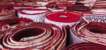 stack of rolled up tradition carpets for prayer Minor Mosque in Tashkent in Uzbekistan photo