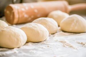 Bakery concept, bread concept. Baking dough lying on the table. photo