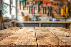 Empty wooden table in the foreground and blurred background with carpenter's tools on the wall. photo