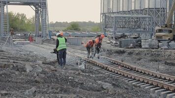 Engineers are building a railway track. A railway engineer carries out repair work on a railway track video