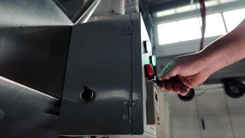 Turning on the switch. Starting the operation of the device in production. Close-up of an employee turning on the toggle switch video