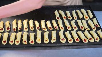 Preparation of sweet cakes with filling at the bakery. The cook prepares the pastry for baking. video