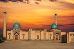 ancient religious Muslim mosque Hazrati Imam part of architectural complex Khast Imam on square in Tashkent at sunset in summer photo