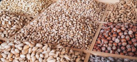 assortment of different nuts on counter at the oriental bazaar. Almonds, pistachios, hazelnuts and cashews photo
