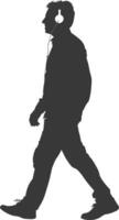 silhouette man walking while listening to headset black color only vector