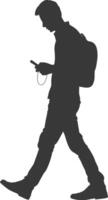 silhouette man walking while playing on smartphone black color only vector