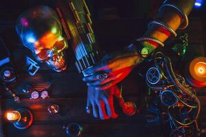 Cyberpunk atmosphere. Hands of a male inventor engineer on a table with various steampunk mechanisms photo