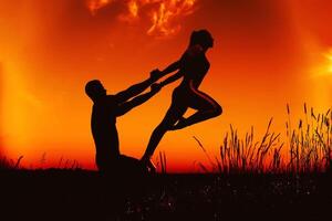 family a man and a girl do a calisthenic exercise for stretching and balance photo