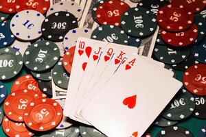 Royal flush in poker on the background of game chips and money dollars photo