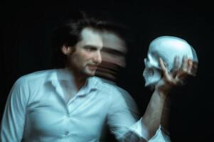 portrait of a psychopathic man with mental disorders with a human skull in hand photo