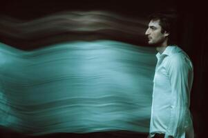 blurred silhouette of ghost man's soul on a dark background photo