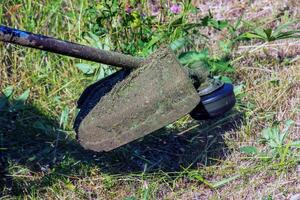 A man cuts and mows the grass. Grass cutting work. Worker mows lawn with grass photo